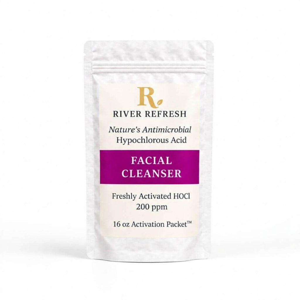 River Refresh Hypochlorous Acid Spray Facial Cleanser Refill Kit n a white resealable pouch with a cream label, featuring a purple banner and gold logo, set against a solid pink background.