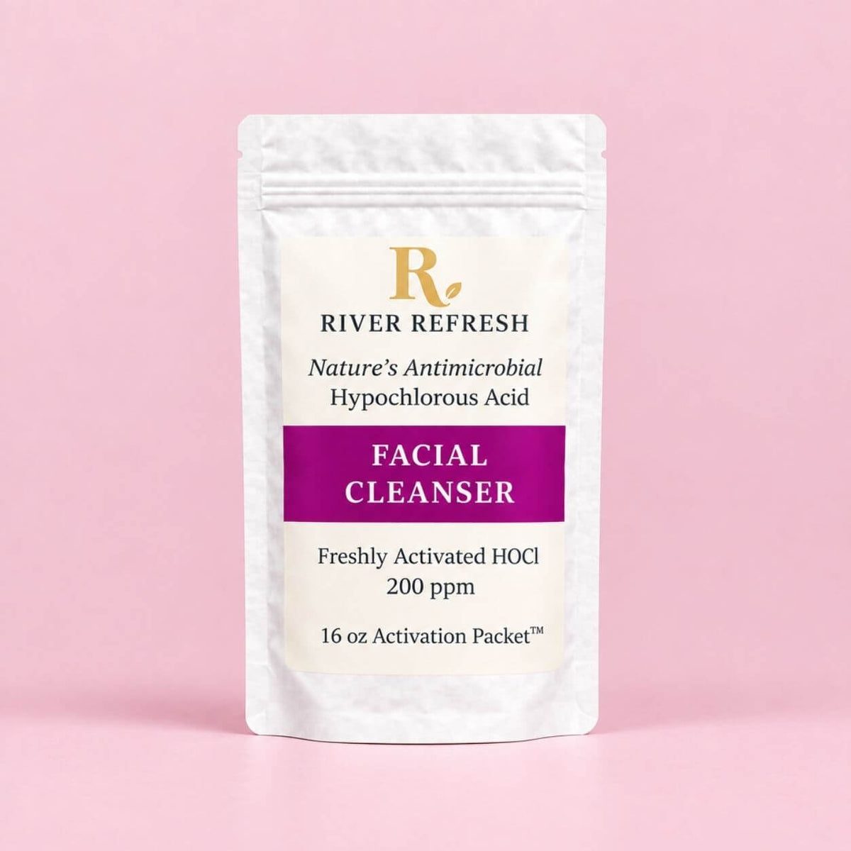 River Refresh Hypochlorous Acid Spray Facial Cleanser Refill Kit n a white resealable pouch with a cream label, featuring a purple banner and gold logo, set against a solid pink background.