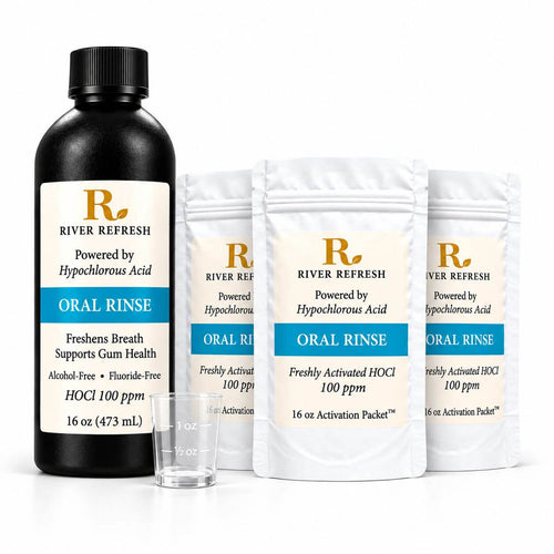 River Refresh Hypochlorous Acid Oral Rinse 48 oz starter kit including a black bottle, three white activation packets, and a small clear measuring cup on a clean white background.