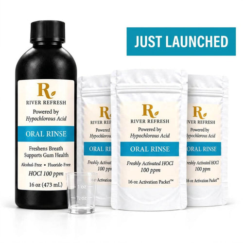 River Refresh Hypochlorous Acid Oral Rinse 48 oz starter kit including a black bottle, three white activation packets, and a small clear measuring cup on a clean white background with a aqua badge in top right that reads Just Launched in white letters.