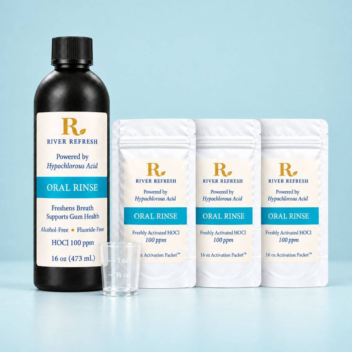 River Refresh Oral Rinse set including a 16 oz black bottle, three activation packets, and a small measuring cup on a light reflective surface. For Product Page