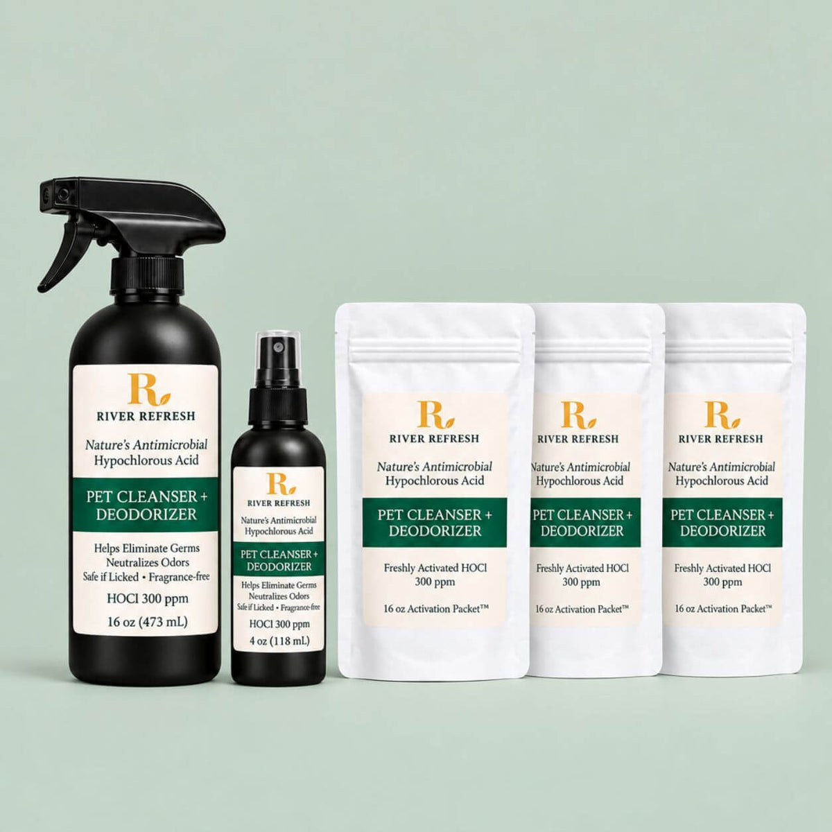 River Refresh Pet Cleanser + Deodorizer set including a 16 oz black spray bottle, a 4 oz black pump bottle, and three 16 oz activation pouches, arranged on a light mint green background.