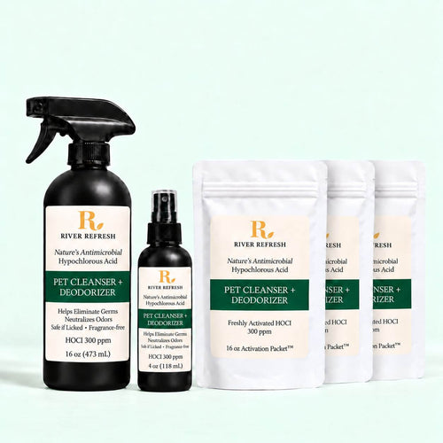 River Refresh Pet Cleanser + Deodorizer set including a 16 oz black spray bottle, a 4 oz black pump bottle, and three 16 oz activation pouches, arranged on a light mint green background.