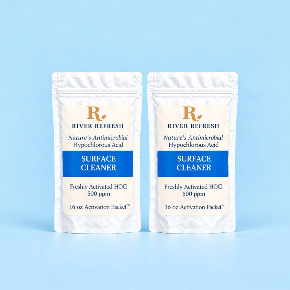 Two stand-up pouches of River Refresh Surface Cleaner Refill 32oz hypochlorous acid activation packets on a light blue background.